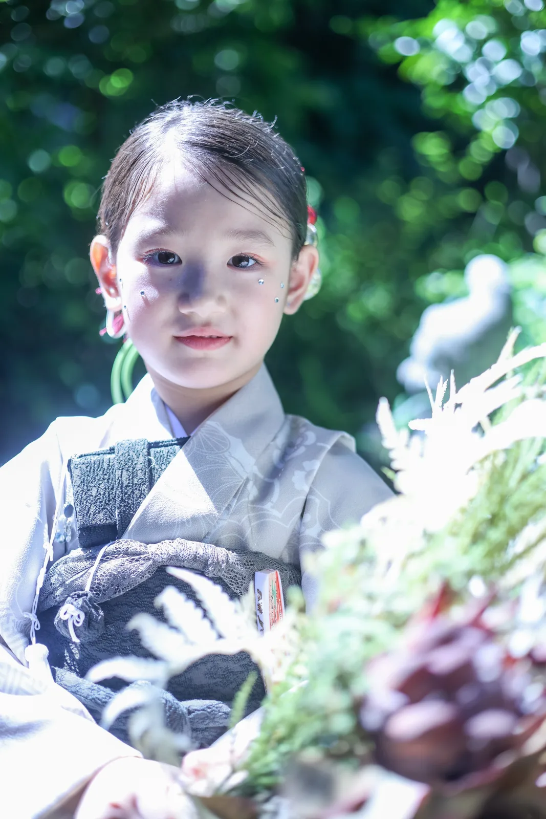 緑の木漏れ日の中のお子さま